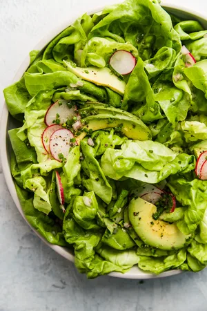 Butter Lettuce Salad with honey mustard vinaigrette in a bowl