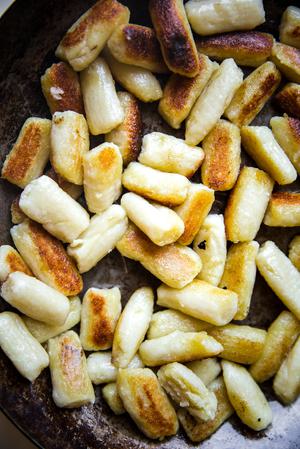 cauliflower gnocchi browned in a sauté pan.