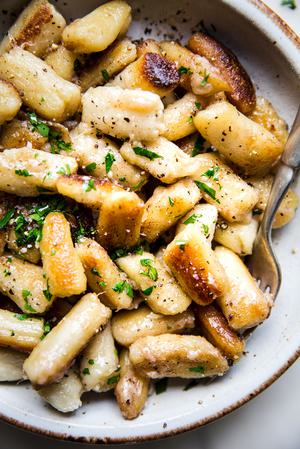 cauliflower gnocchi in a bowl with a spoon.