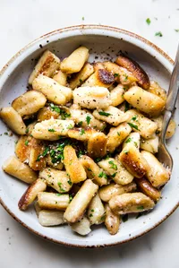cauliflower gnocchi in a bowl with a spoon.