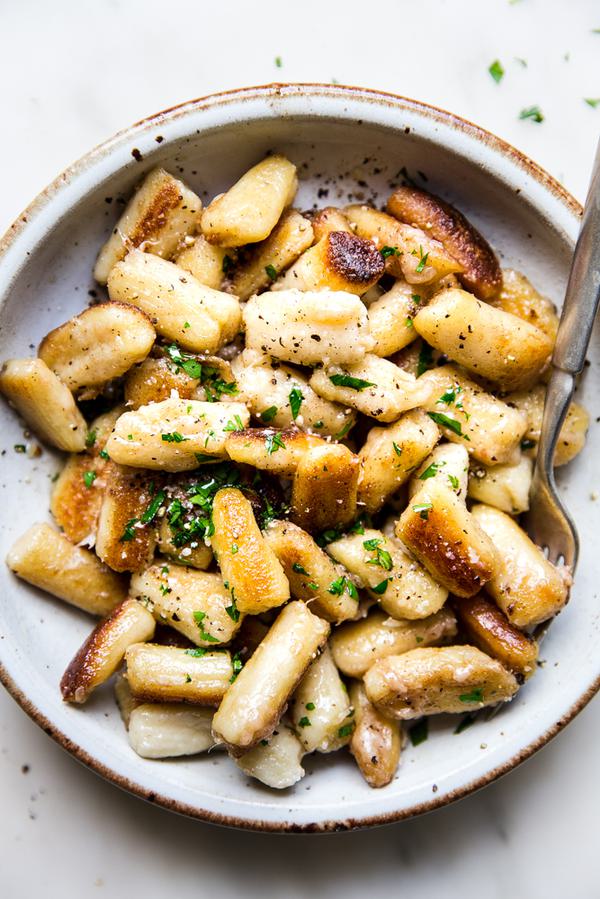 cauliflower gnocchi in a bowl with a spoon.