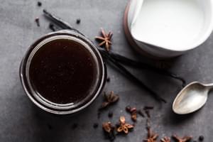 homemade chai tea in a jar next to milk