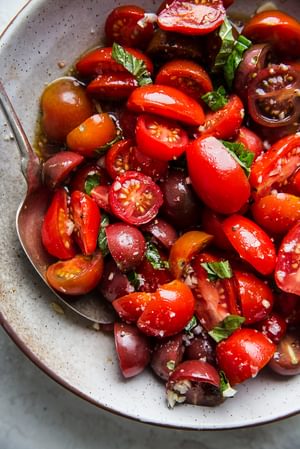 marinated tomato salad ingredients cherry tomatoes, balsamic, salt and garlic, lemon, basil, pepper and olive oil