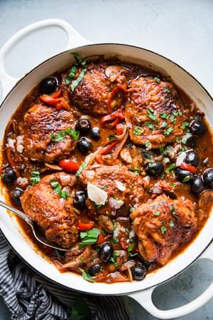 homemade chicken cacciatore recipe in a while pot with olives and tomatoes.
