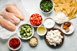 Ingredients for chicken shawarma nachos shown in small bowls