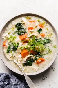 A bowl of homemade chicken and rice soup with chicken, vegetables, and herbs in a comforting broth, perfect for cold days.