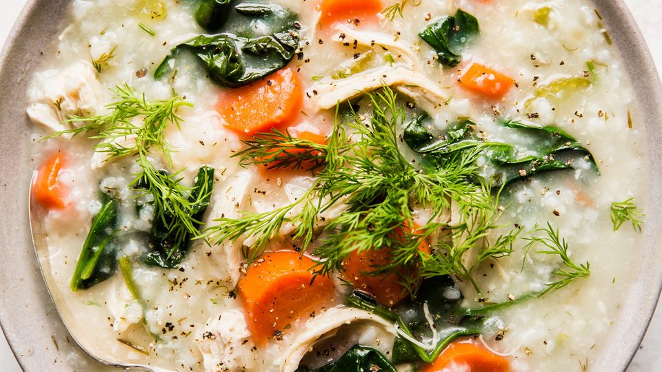 A bowl of homemade chicken and rice soup with chicken, vegetables, and herbs in a comforting broth, perfect for cold days.