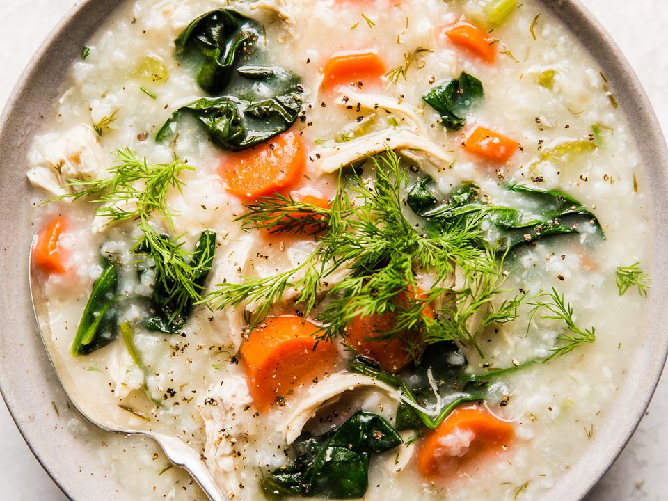 A bowl of homemade chicken and rice soup with chicken, vegetables, and herbs in a comforting broth, perfect for cold days.