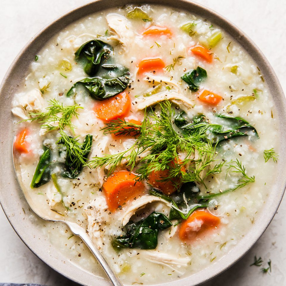 A bowl of homemade chicken and rice soup with chicken, vegetables, and herbs in a comforting broth, perfect for cold days.