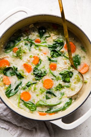 A pot of homemade chicken and rice soup with chicken, vegetables, and herbs in a comforting broth, a great family meal.