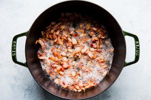 bacon pieces cooking in a soup pot