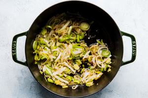 leeks and garlic cooking in butter and bacon fat in a soup pot