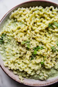Creamy Zucchini Pasta Sauce with pasta in a bowl with basil.