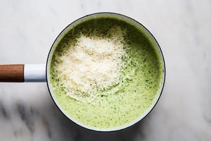 creamy zucchini sauce in a pot with parmesan cheese