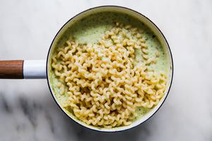 creamy pasta sauce in a pot with pasta noodles