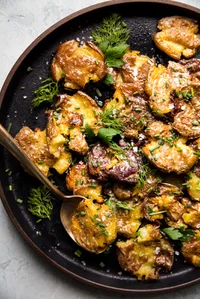 Crispy Smashed Potatoes on a black plate
