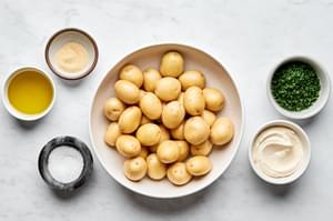 baby yukon gold potatoes olive oil, salt, garlic powder, chives & garlic aoili in prep bowls to make crispy smashed potatoes