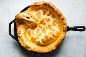 puffy crispy Dutch baby pancake fresh out of the oven in a cast iron skillet