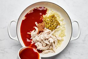 chicken, taco seasoning, green chilies and enchilada sauce in a skillet, to make a simple enchilada skillet