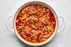 chicken, taco seasoning, green chilies, enchilada sauce and sliced corn tortillas stirred together in a skillet