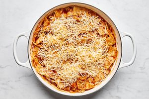 chicken enchilada skillet topped with cheese ready to be finished in the oven