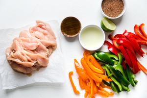 ingredients laid out for chicken fajitas taco seasoning, lime juice, bell peppers