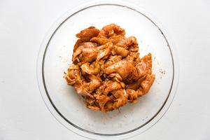 chicken breast marinaded in taco seasoning in a bowl
