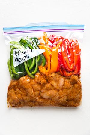 chicken fajitas dinner in a ziplock bag getting ready to be put in the freezer