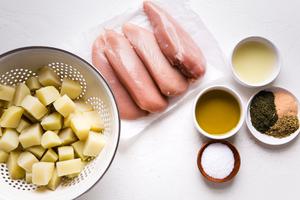 ingredients laid out for Freezer Greek lemon Chicken and potatoes olive oil, oregano dill garlic