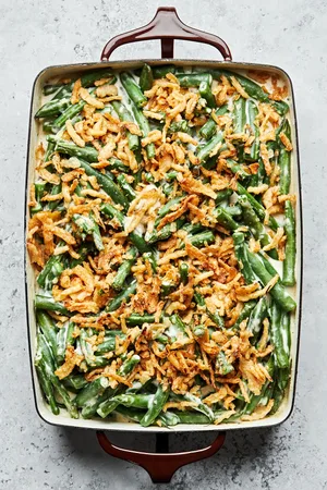 homemade green bean casserole with a creamy sauce, topped with French fried onions in a casserole dish