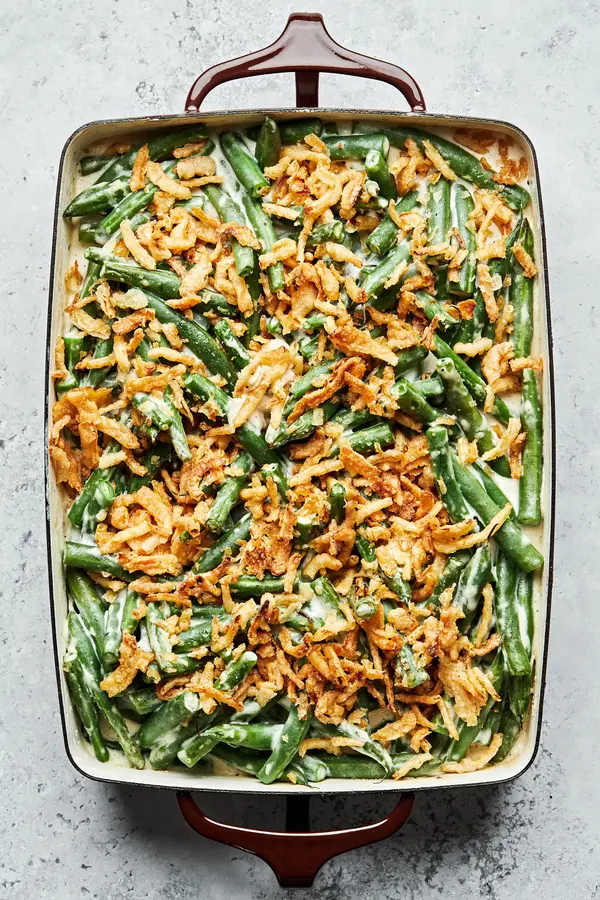 homemade green bean casserole with a creamy sauce, topped with French fried onions in a casserole dish