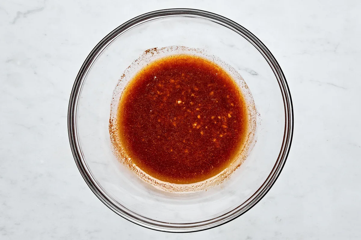 Homemade marinade sauce in a glass bowl for grilled scallops seasoning.