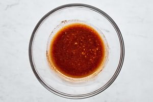 Homemade marinade sauce in a glass bowl for grilled scallops seasoning.