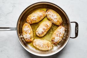 roasted hasselback potatoes with herb butter and sprinkled with Parmesan