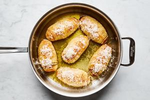roasted hasselback potatoes with herb butter and sprinkled with Parmesan