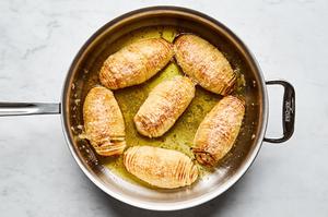 roasted hasselback potatoes with herb butter and sprinkled with Parmesan
