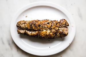 Herb crusted Pork Tenderloin resting on a plate