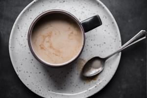 A mug of Chai tea made with Homemade Chai tea concentrate with a spoon