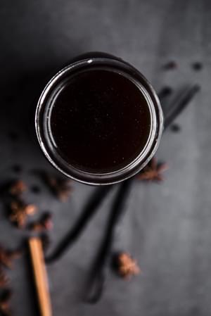 Homemade Chai Tea Concentrate in a jar with cinnamon, star anise and vanilla
