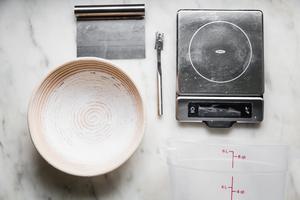 scale, bread lame, bench scraper and proofing basket