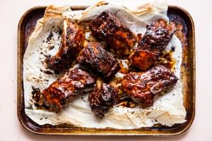 broiled pork ribs with sauce on parchment paper