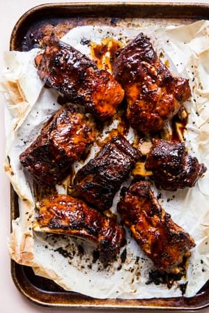 broiled pork ribs with sauce on parchment paper