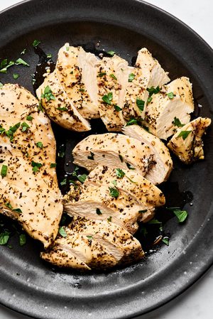perfectly cooked juicy chicken breast cooked in the instant pot and sliced and arranged on a plate