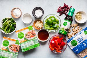 Ingredients laid out for Kung pan tofu with green onions and bell peppers, soy sauce cashews