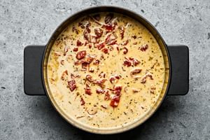 creamy sauce in a skillet made with heavy cream, chicken stock, bouillon, Parmesan, sun-dried tomatoes & Italian seasoning