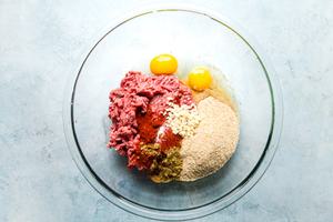 eggs, breadcrumbs, ground beef, cumin, chili powder garlic and smoked paprika in a glass bowl