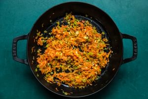 shallot, celery, carrots and garlic being cooked in olive oil in a saucepan for mushroom ragù