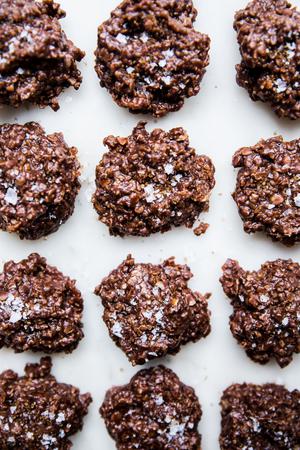 peanut butter and chocolatey no-bake cookies topped with flaky sea salt and raw sugar on the counter