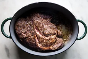 Pot roast seasoned with salt and pepper browned in a large dutch oven