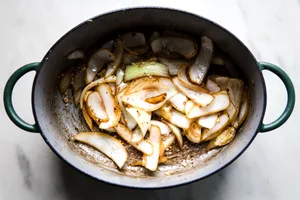 Onion wedges sautéed in a large dutch oven